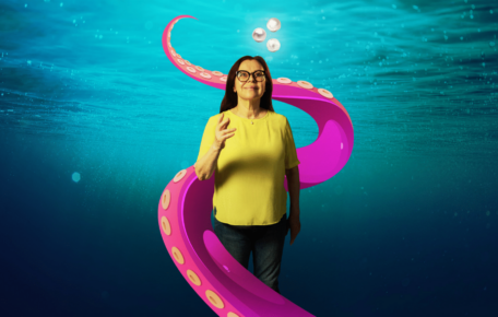 A person in an underwater world, being wrapped into a tentacle.