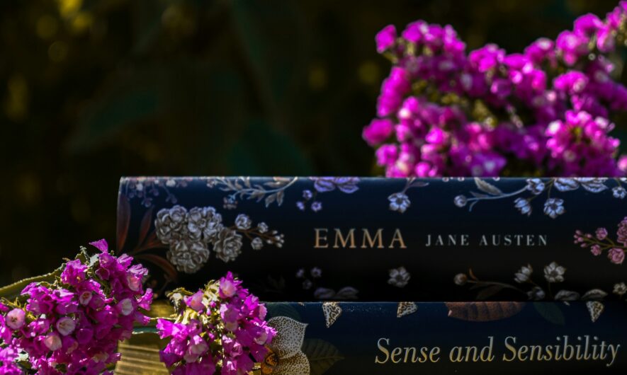 A series of Austen novels stacked ontop of each other with purple flowers surrounding the books.